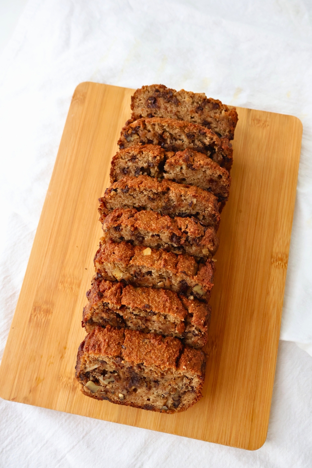 Freshly baked banana bread cooling in a loaf pan, dairy free and gluten free.