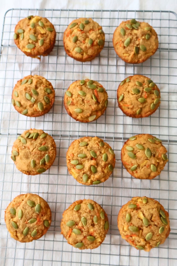 Freshly baked Paleo Morning Glory Muffins cooling on a wire rack.